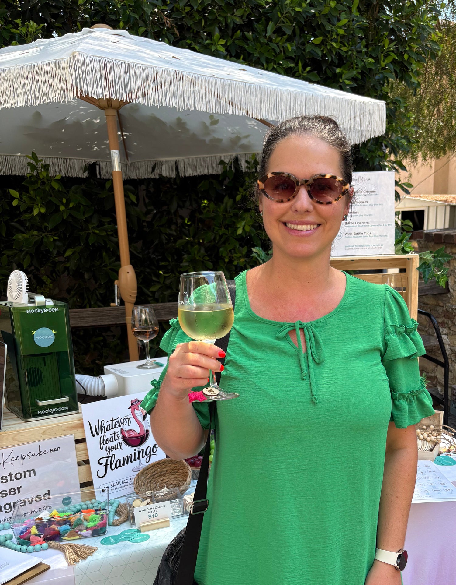 Happy customer holding a wine glass with a custom wine glass charm